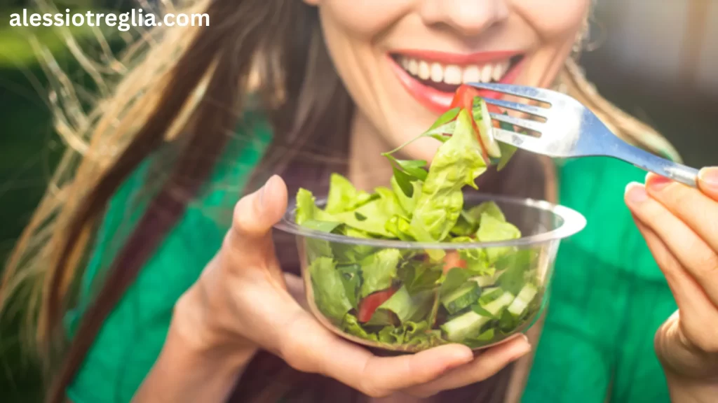 Woman eating a fresh salad. Can you eat after a filling? Learn which soft foods are safe to eat after dental work to ensure a smooth recovery and protect your teeth.